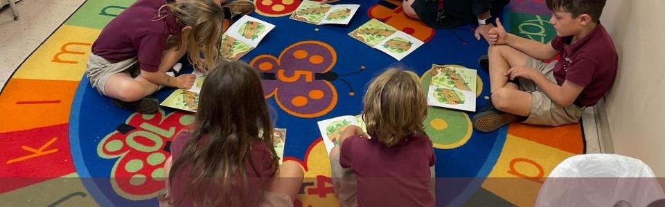 kindergarten children doing phonics lessons on school mat