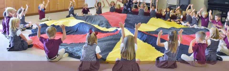 children doing parachute activity at classical school